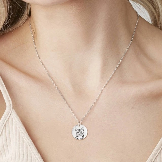 Silver custom cat portrait necklace worn on model
